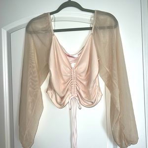light pink top with sheer bell sleeves